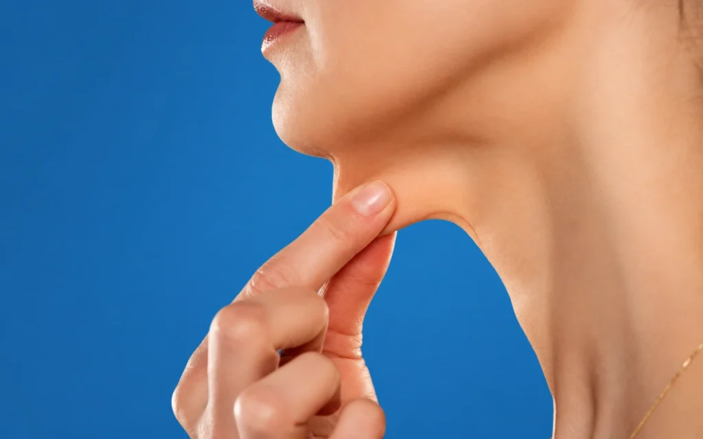 Loose neck skin being gently lifted to illustrate skin laxity and skin tightening treatment